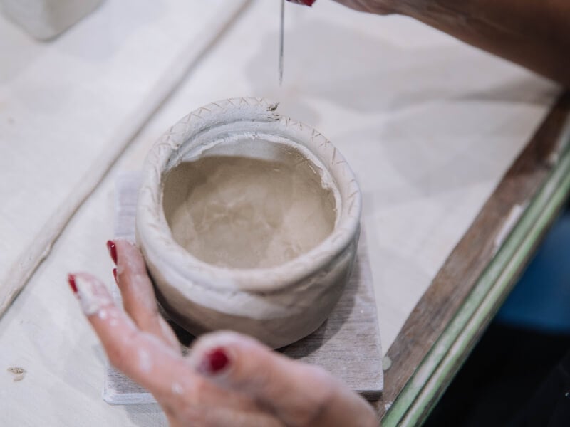 hand building a ceramic mug